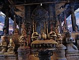 
Kathmandu Patan Golden Temple - The Entrance Door To The Swayambhu Chaitya Is Guarded By Two Snow Lions And Has A Vajra And Many Statues Including The King And Queen
